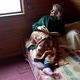 Woman in Old Age Sits on a Bed Under a Blanket with a Book in Her Hand - VideoHive Item for Sale