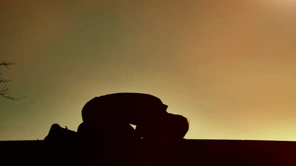 Religious Man Bows on Sunset alt