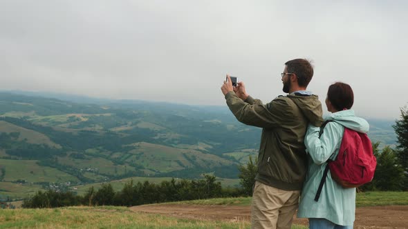 Tourists Take Pictures in the Mountains