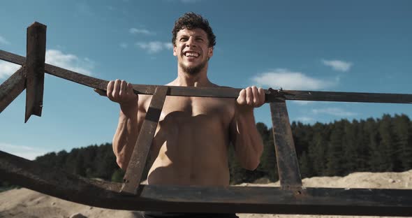 Athletic Muscular Man Doing Biceps Workout Outdoor. Slow Motion. Concept of Motivation and Sports