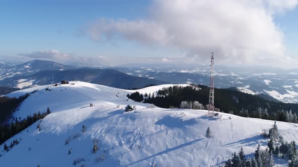 Flying Over Radio Communications Tower, Mountain Snow Covered Winter Landscape