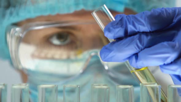 Lab Expert Adding Chemical Agent to Urine Sample in Test Tube, Health Check