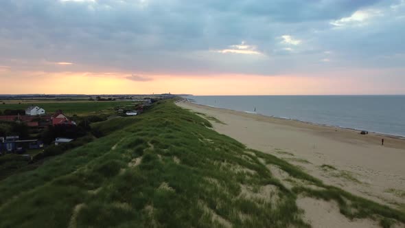 Aerial flying over sand and dunes on Eccles Beach in Norfolk, England