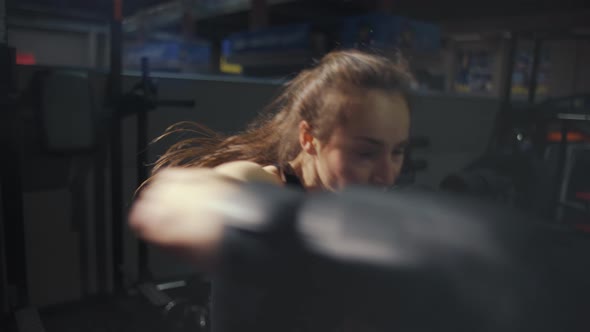 Female Boxer Shaking Camera During Training in Gloves with Bag