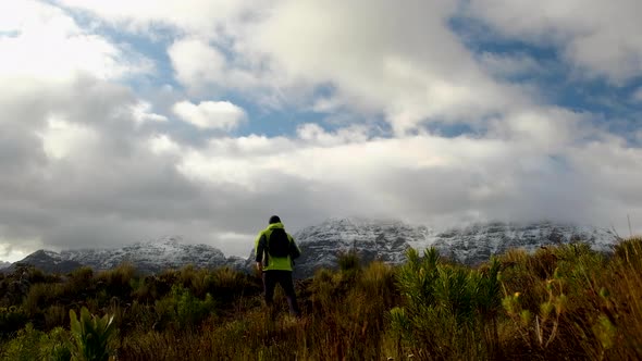 Snowy mountain revealed to hiker going over hill, South Africa, static shot