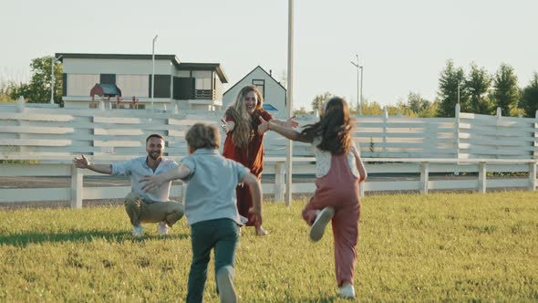 Siblings Running and Hugging Parents