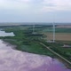 Wind generators on the shore of the pink lake. Aerial view in the evening - VideoHive Item for Sale