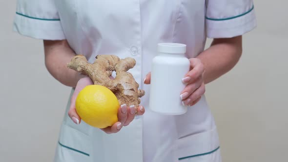 Nutritionist Doctor Healthy Lifestyle Concept - Holding Ginger Root, Lemon and Vitamin Pills