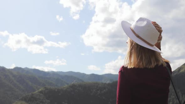 Young Woman Hiker Tourist in Hat Admiring Amazing View in Mountains Valley