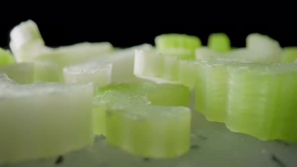 Sliced Slices of Fresh Juicy Celery Stalk on a Gray Plastic Board