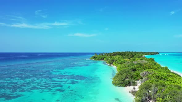 Beautiful birds eye island view of a sandy white paradise beach and aqua blue water background 