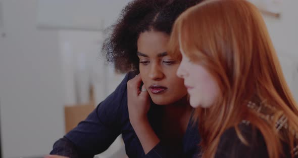 Female Coworkers Discussing in Office