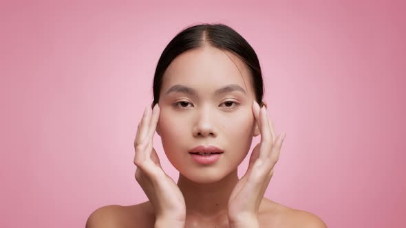 Japanese Woman Making Massage With Fingers Posing Over Pink Background