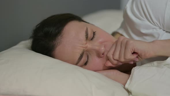 Young Woman with Cough Laying in Bed