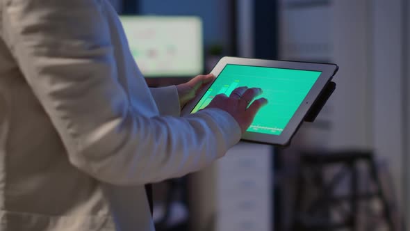 Closeup Photo of Woman Hands Holding Tablet Computer Analysing Graphs