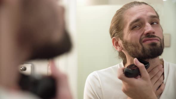 Men Face Hygiene. Man Shaving Beard And Feeling Painful