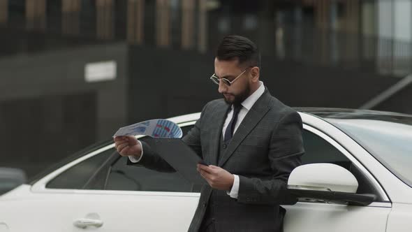 Stylish Businessman Working by Car