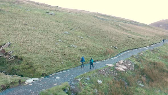 Aerial view of people hiking and climbing Snowdon mount in Wales on a sunny d