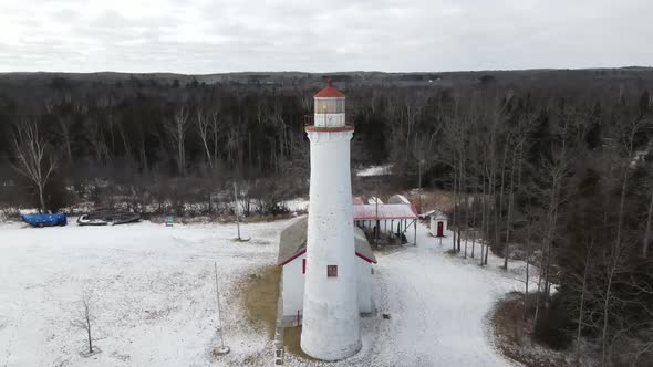 4k drone video of Sturgeon Point Lighthouse in Sturgeon Point Lighthouse in Michigan during the wint