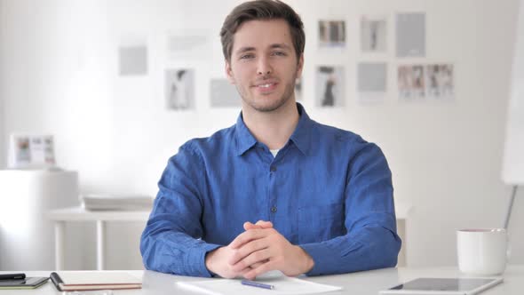 Successful Smiling Casual Adult Man Sitting at Workplace