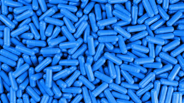 Blue Pharmaceutical Capsules Rotating Slowly