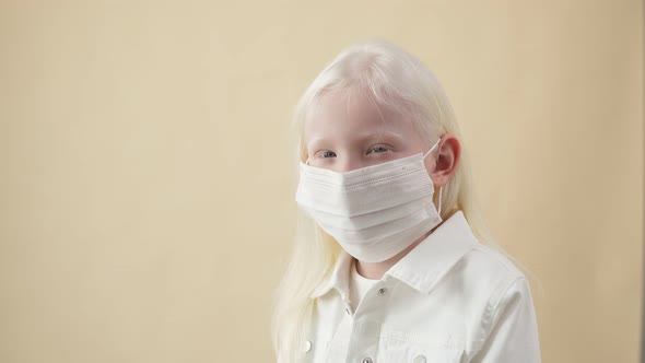 Coronavirus, Covid-19 Concept. Albino Child in Medical Mask.