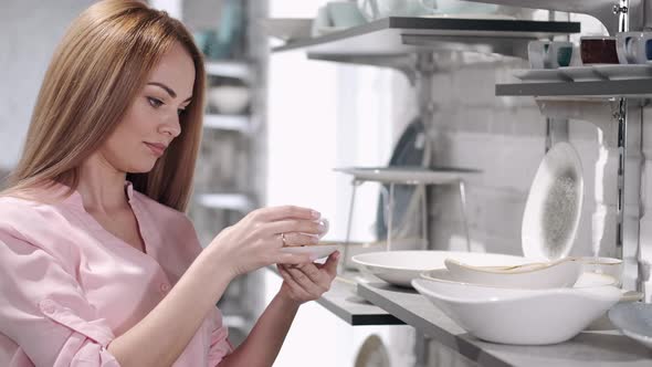 The Pretty Housewife Is Choosing China Crockery at the Kitchen Ware Store