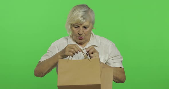 An Elderly Woman with Shopping Bags. Shopping. Presents. Chroma Key