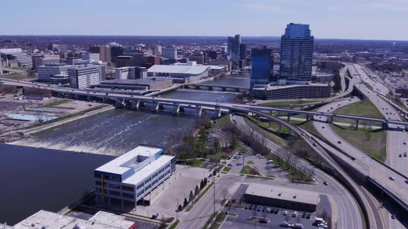 High wide aerial pan of highways, Grand River and Grand Rapids skyline