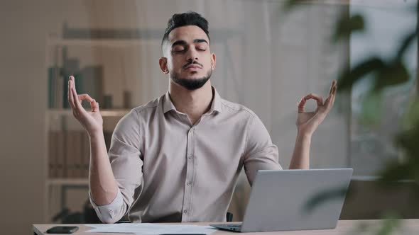 Calm Arabian Business Man Professional Worker Eyes Closed Taking Break Meditating on Work Desk