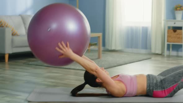 Pretty Woman Is Doing Exercise with Gym Ball