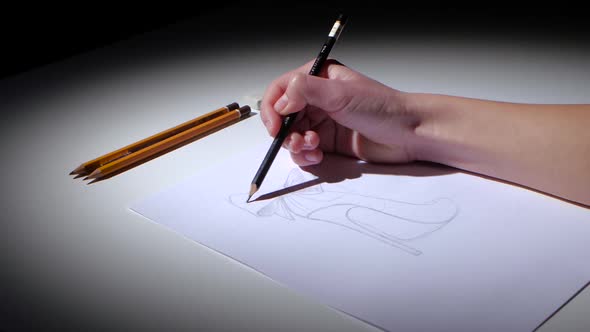 Girl Draws Sketch of Women's Shoes with Pencil and Eraser. Close Up