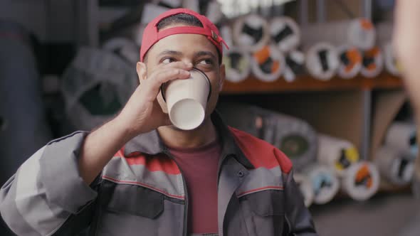 Middle-Eastern Warehouse Worker Drinking Coffee