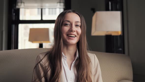 Business Woman Sitting in Soft Chair Calling Video Chat Conference in Lobby