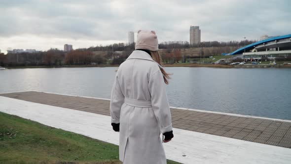Girl Walks Along the Stunning Embankment