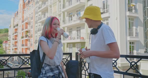 Urban Lifestyle of Teenagers, Couple of College Students Talking Having Rest Drinking Milk Drink in