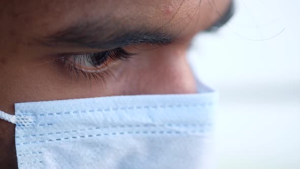 Close Up of Man with Protective Face Mask Looking at Camera