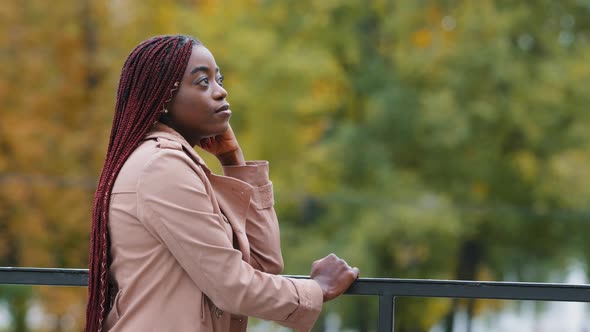 Thoughtful Pensive Upset Young Woman Stands Outdoors Looking to Side Thinks About Future Deep in