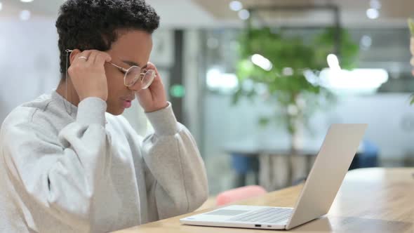 Casual African Woman with Laptop Having Headache