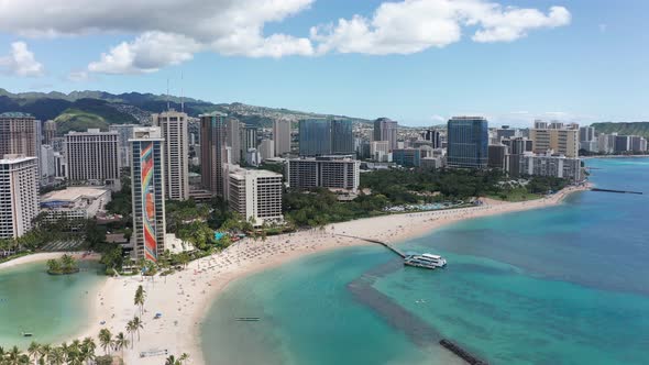 Aerial decreasing and panning shot of Waikiki on the island of O'ahu, Hawaii. 4K