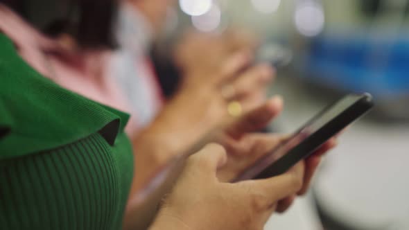 Young People Using Mobile Phone in Public Underground Train