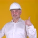 Cheerful Senior man builder in helmet hold in hand bank credit card showing thumbs up - VideoHive Item for Sale