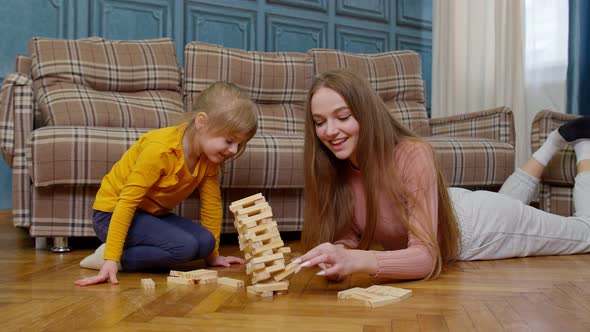 Mother Play Wooden Blocks Board Game with Little Daughter Child Girl at Home Leisure Hobbies