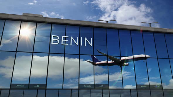 Airplane landing at Benin Nigeria airport mirrored in terminal