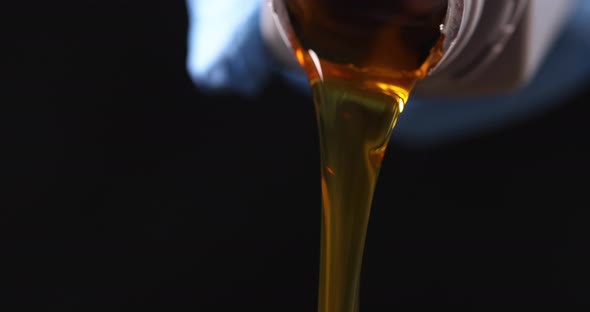Clear Yellow Oil is Poured From Plastic Bottle Slow Motion  Movie