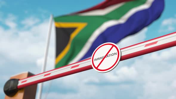 Barrier with No Immigration Sign Opened at Flag of South Africa