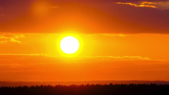 Timelapse Sunset in the Sky Big Bright Yellow Sun Moves Down on the Horizon