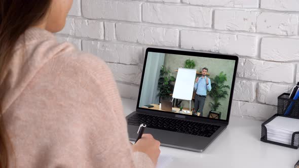 Woman Study Online Course Webcam Laptop Writes in Notebook Listen Teacher