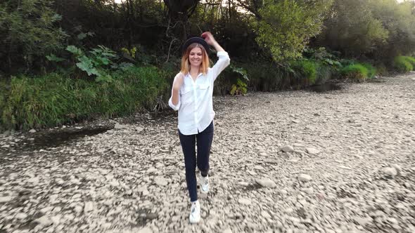 Aerial Drone View of Young Woman Walk Along Mountains River in Summer Morning