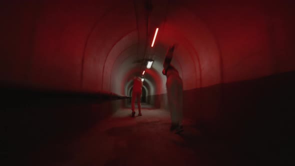 Two Boys Freerunning and Doing Parkour Flips in Tunnel